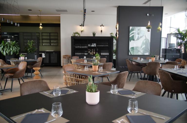 Ristorante moderno con arredamento elegante e piante.